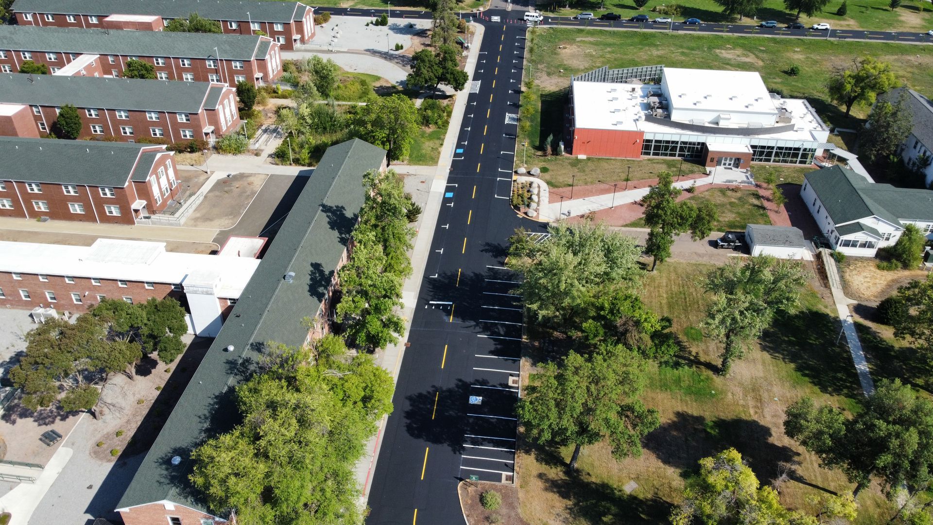 An aerial view of a road surrounded by buildings and trees.
