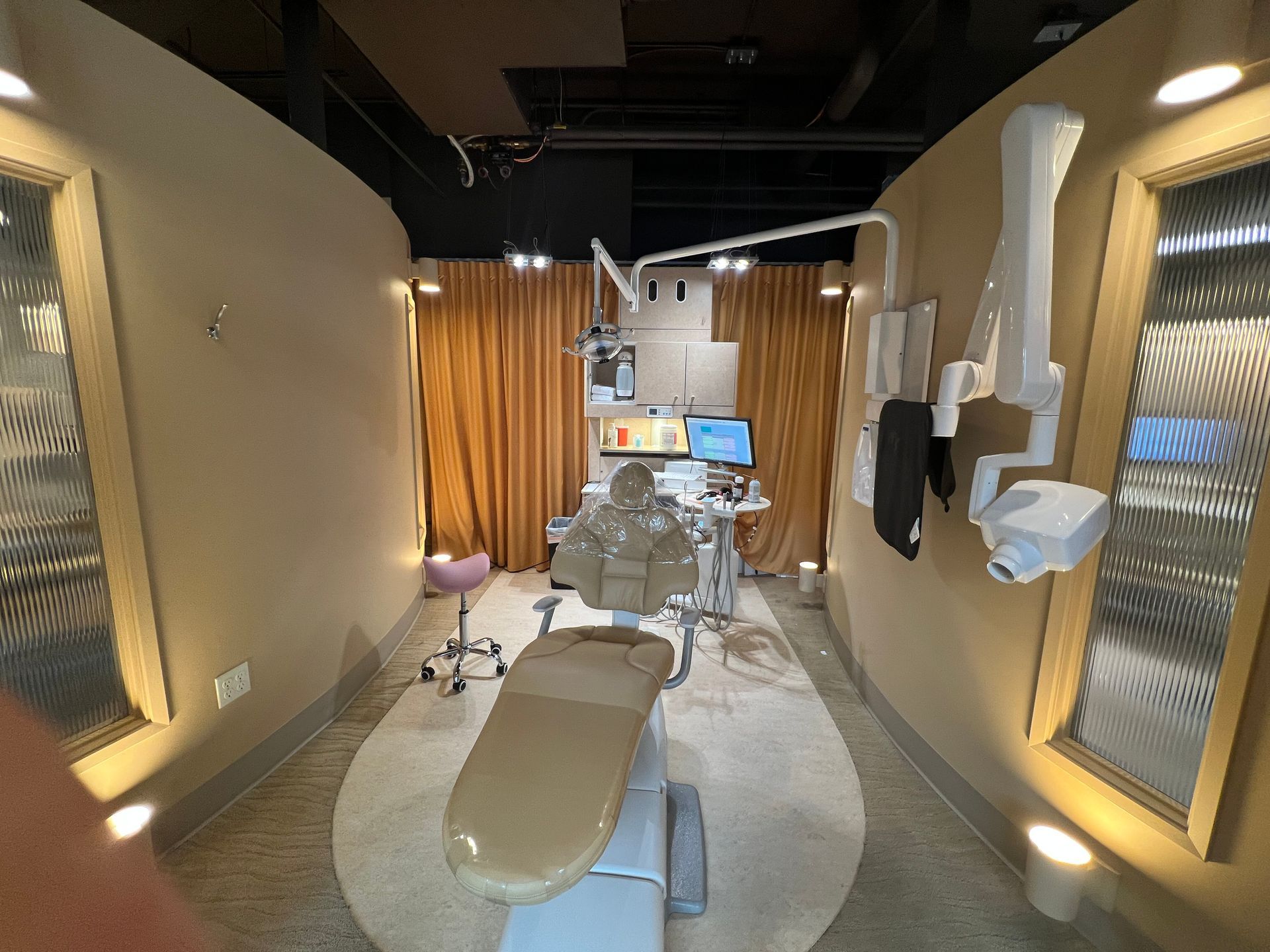 A dental office with a dental chair and a computer