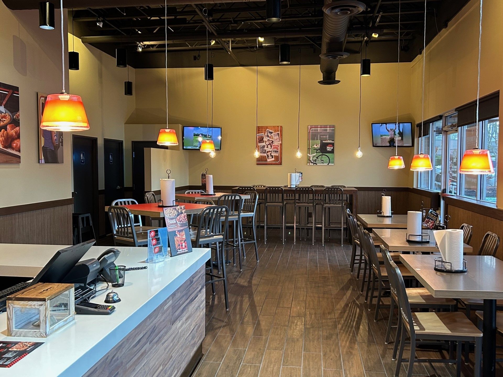 a restaurant with tables and chairs and a counter