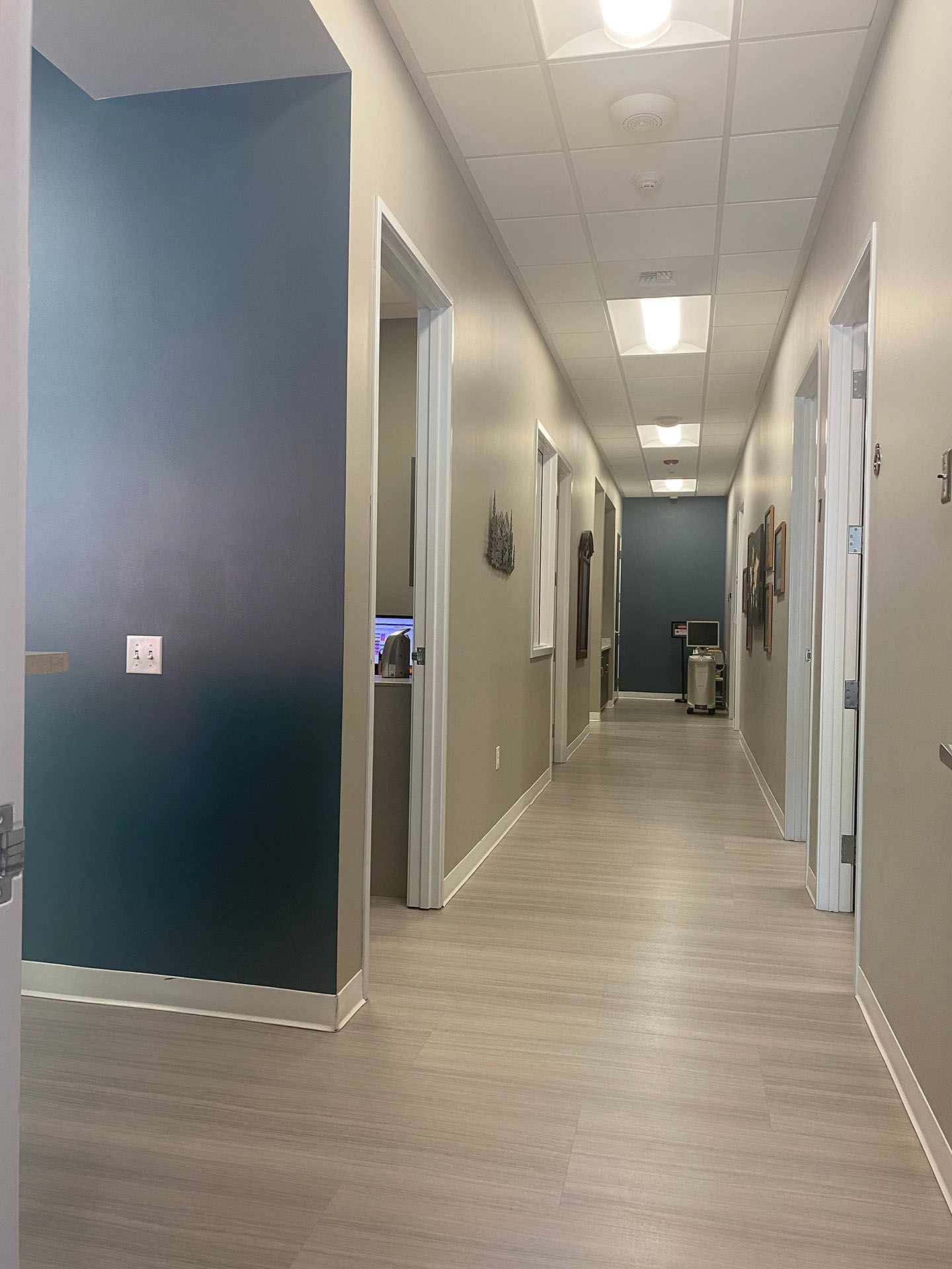 A long hallway with a lot of doors and windows