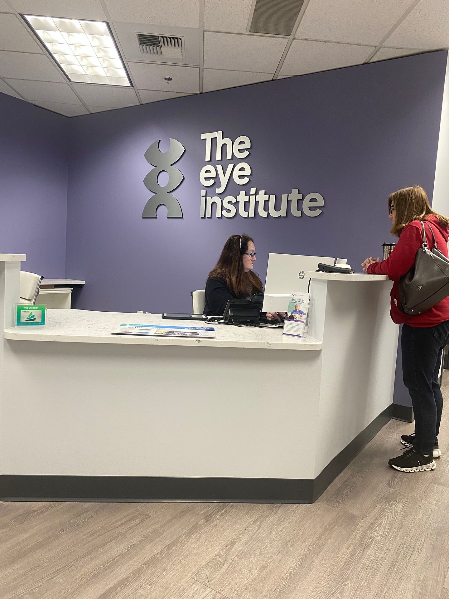 A receptionist talking to her client
