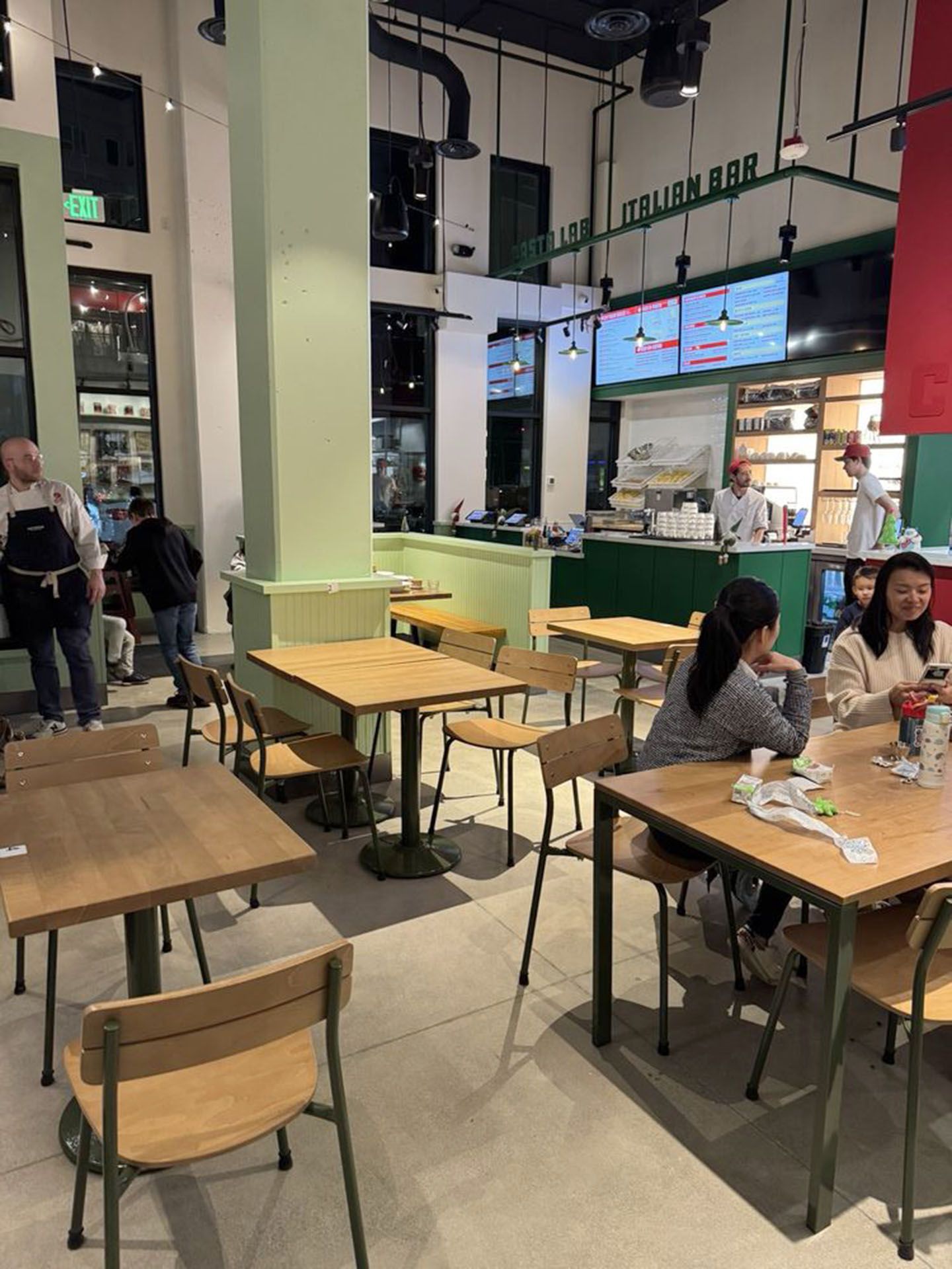 A group of people are sitting at tables in a restaurant