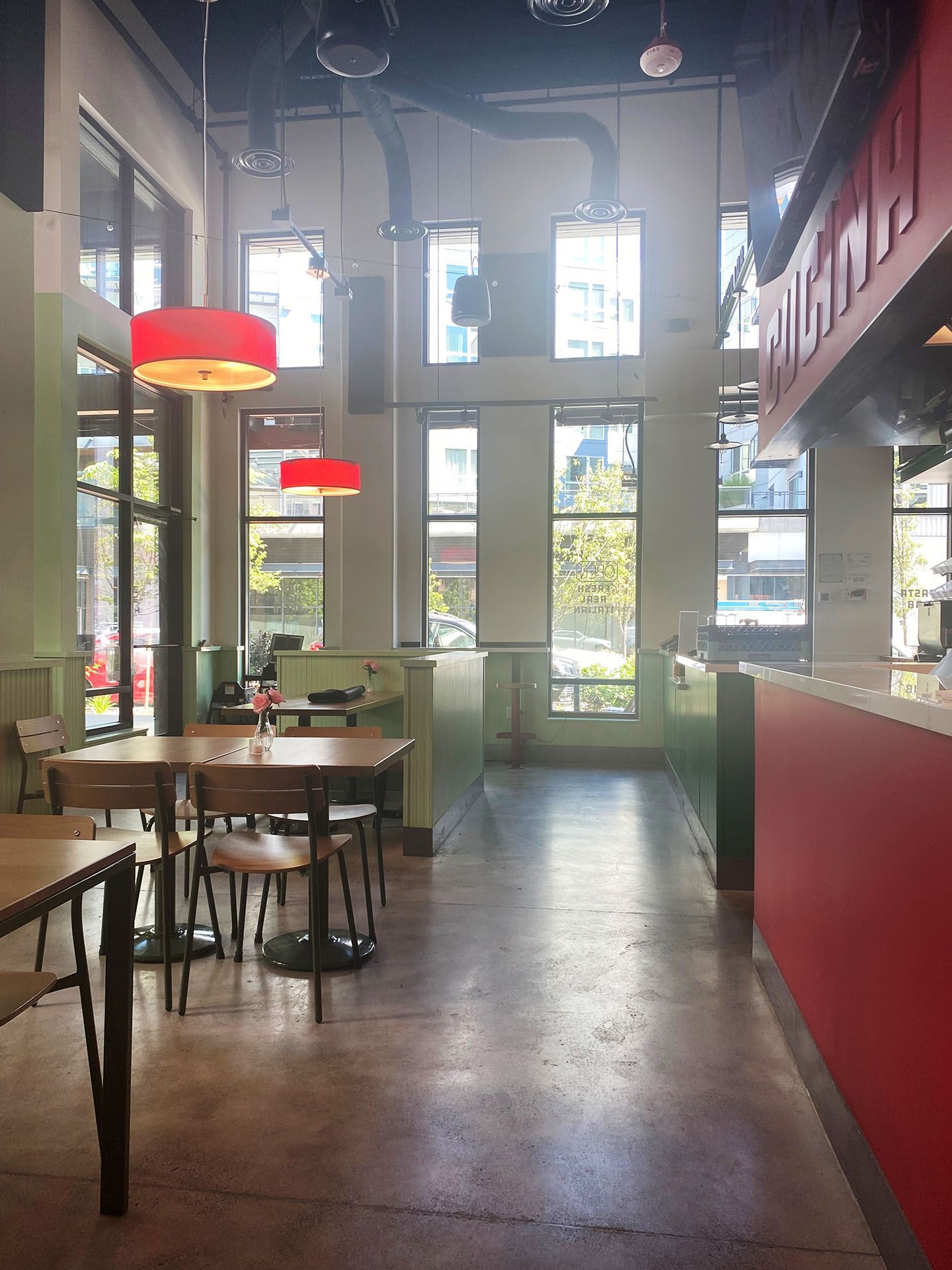 The inside of a spacious restaurant with tables and chairs