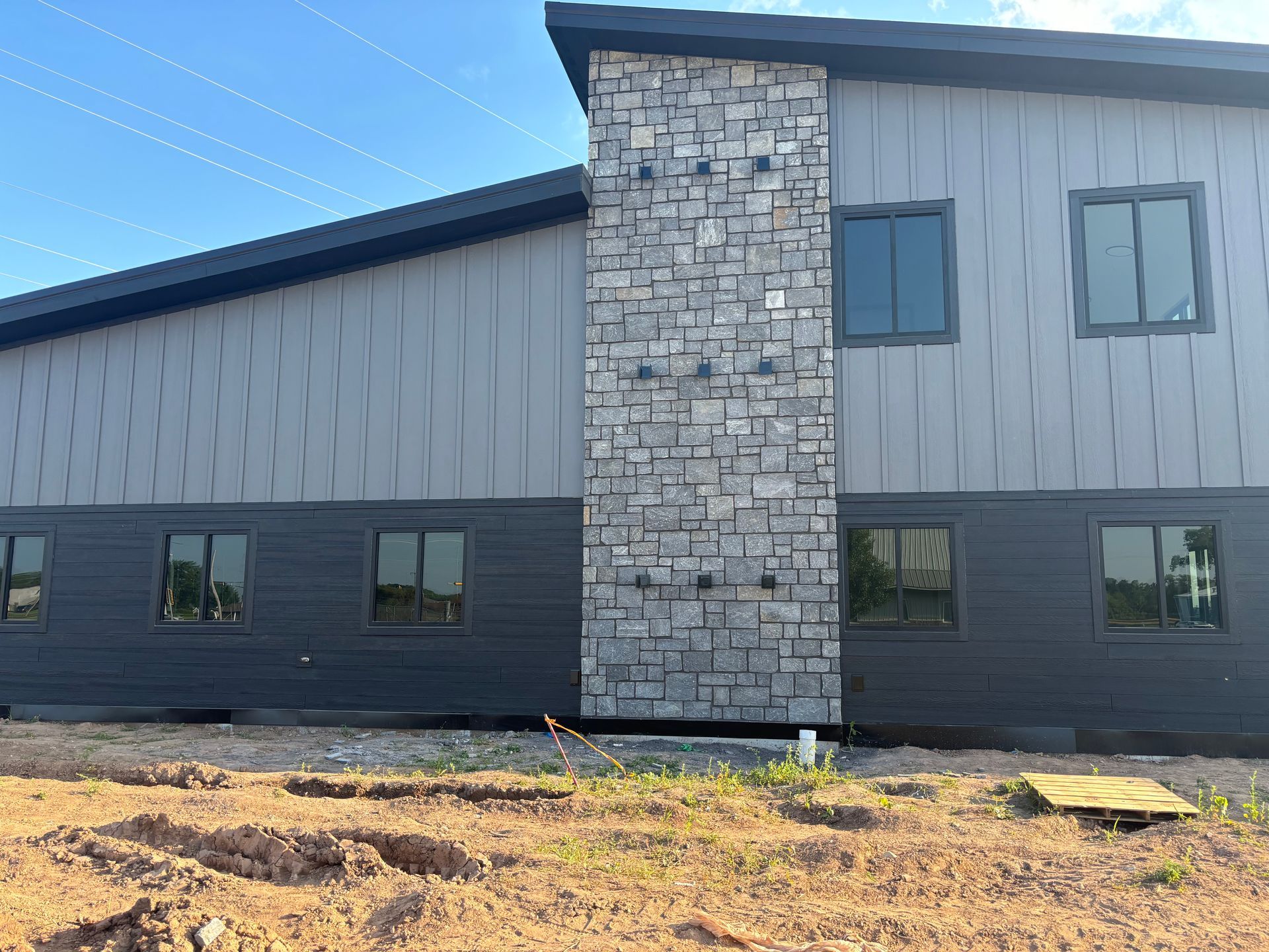 A large building with a stone chimney on the side of it.
