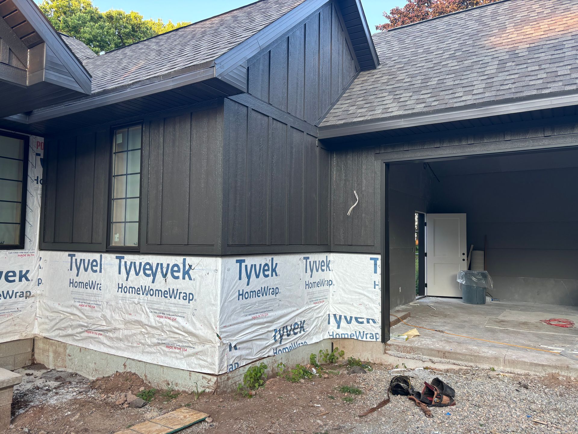 A house is being built with a garage and a roof.