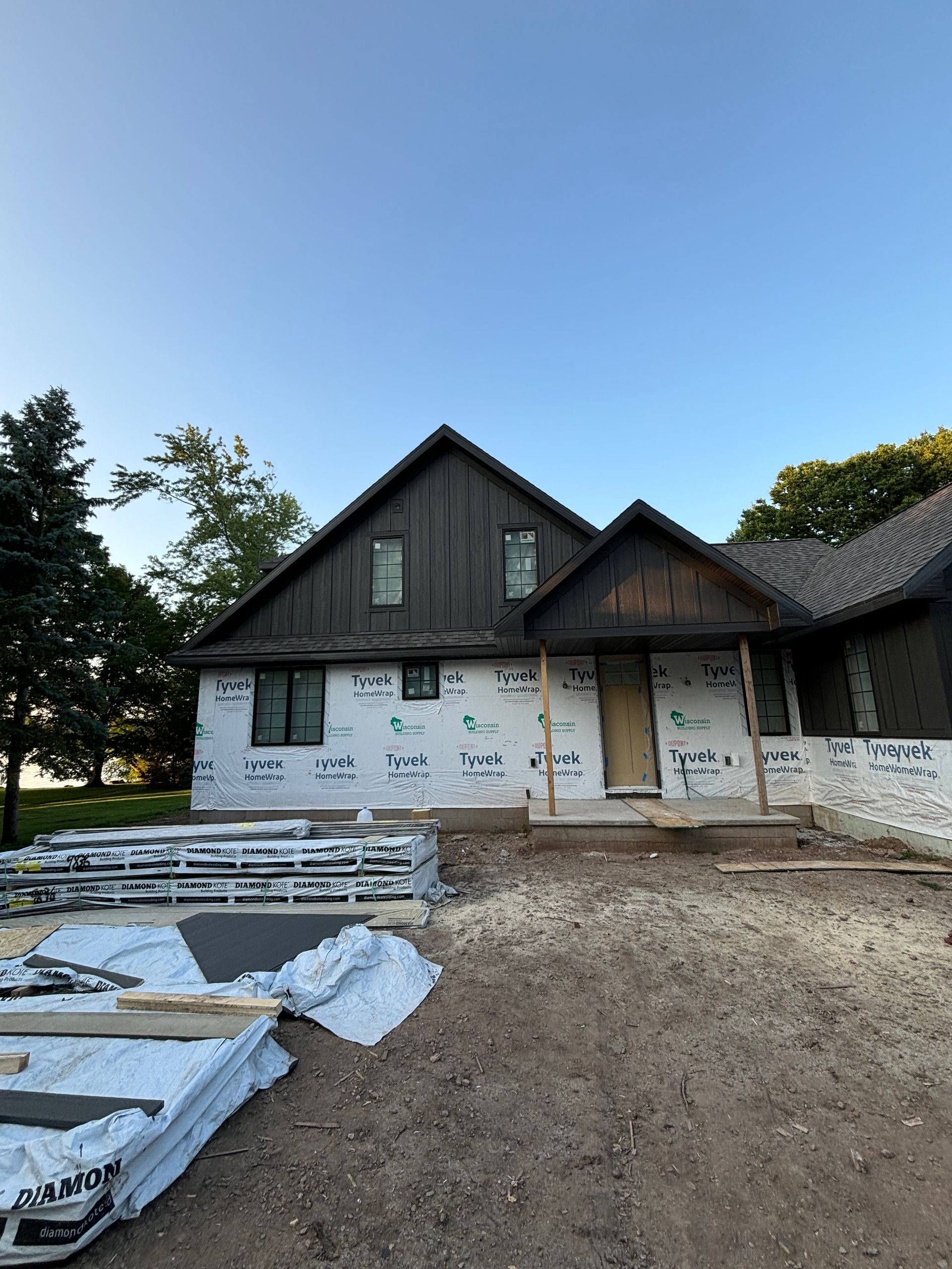 A house that is being built with a blue sky in the background.