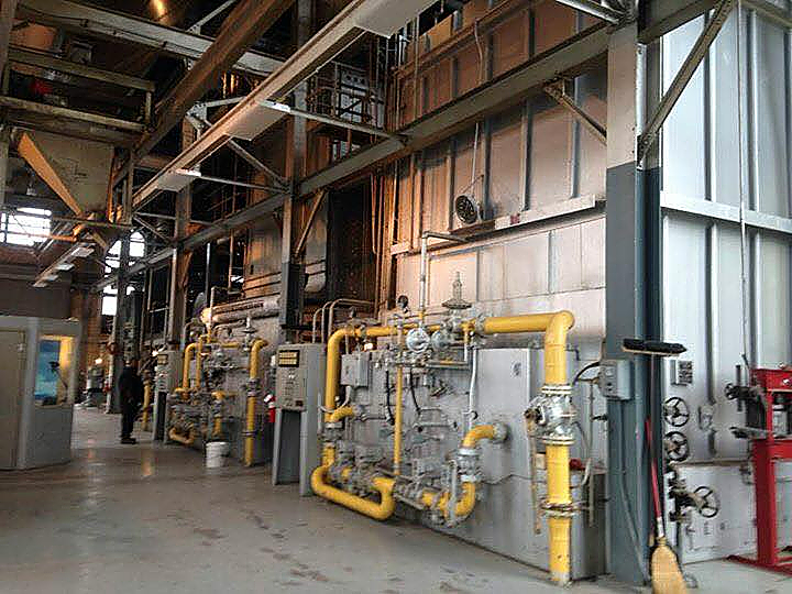 A large industrial building with lots of pipes and machinery.