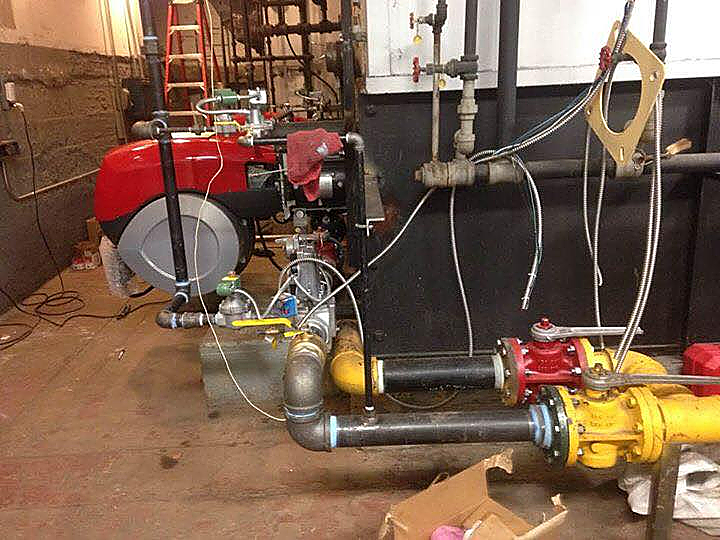 A bunch of pipes are connected to each other in a room.