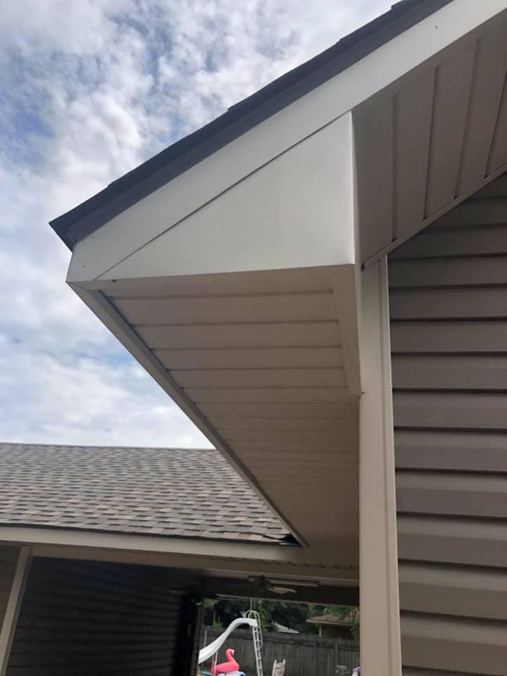 A close up of the roof of a house with a gutter on it.