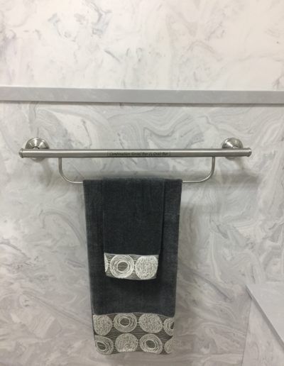 A towel is hanging on a towel rack in a bathroom.