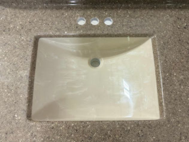A bathroom sink is sitting on top of a counter.