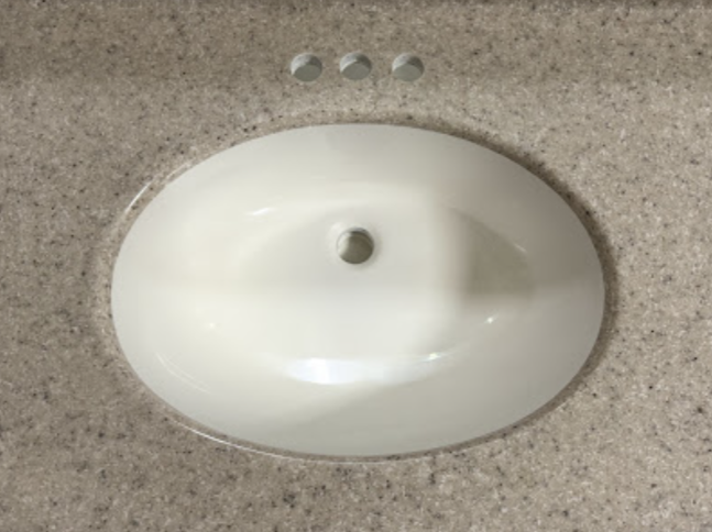 A bathroom sink with a hole in the middle of it.
