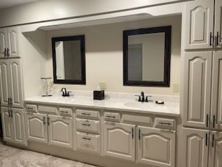 A bathroom with two sinks and two mirrors.