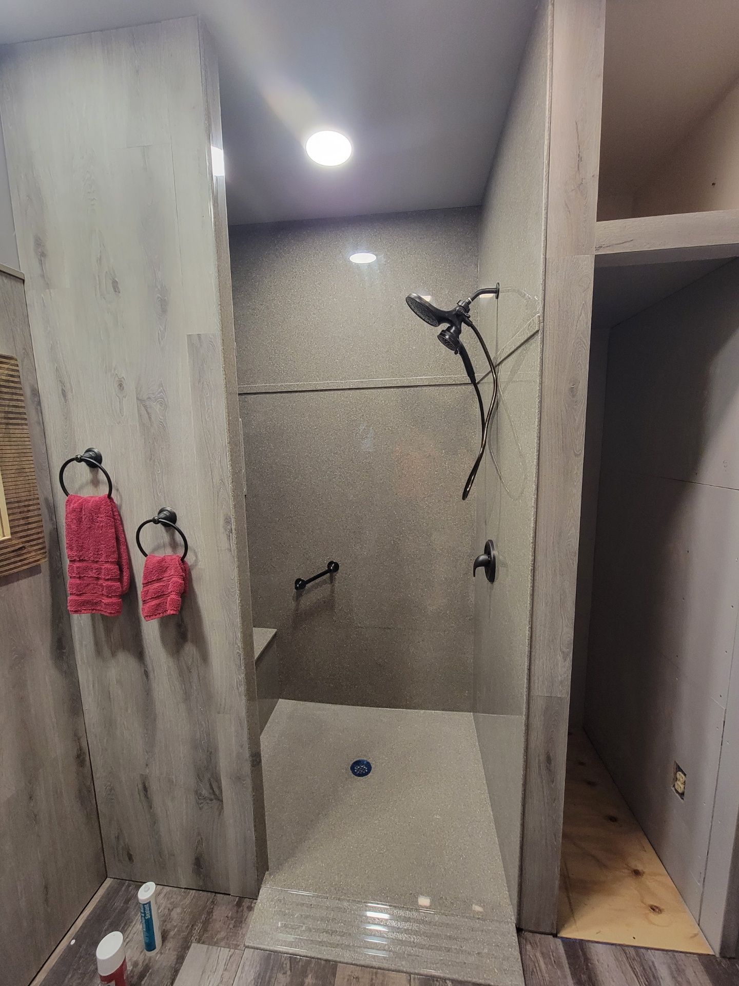 A bathroom with a walk in shower and a mirror.
