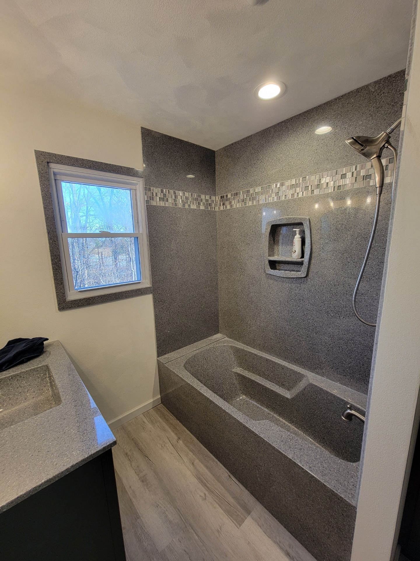 A bathroom with a bathtub and a shower.