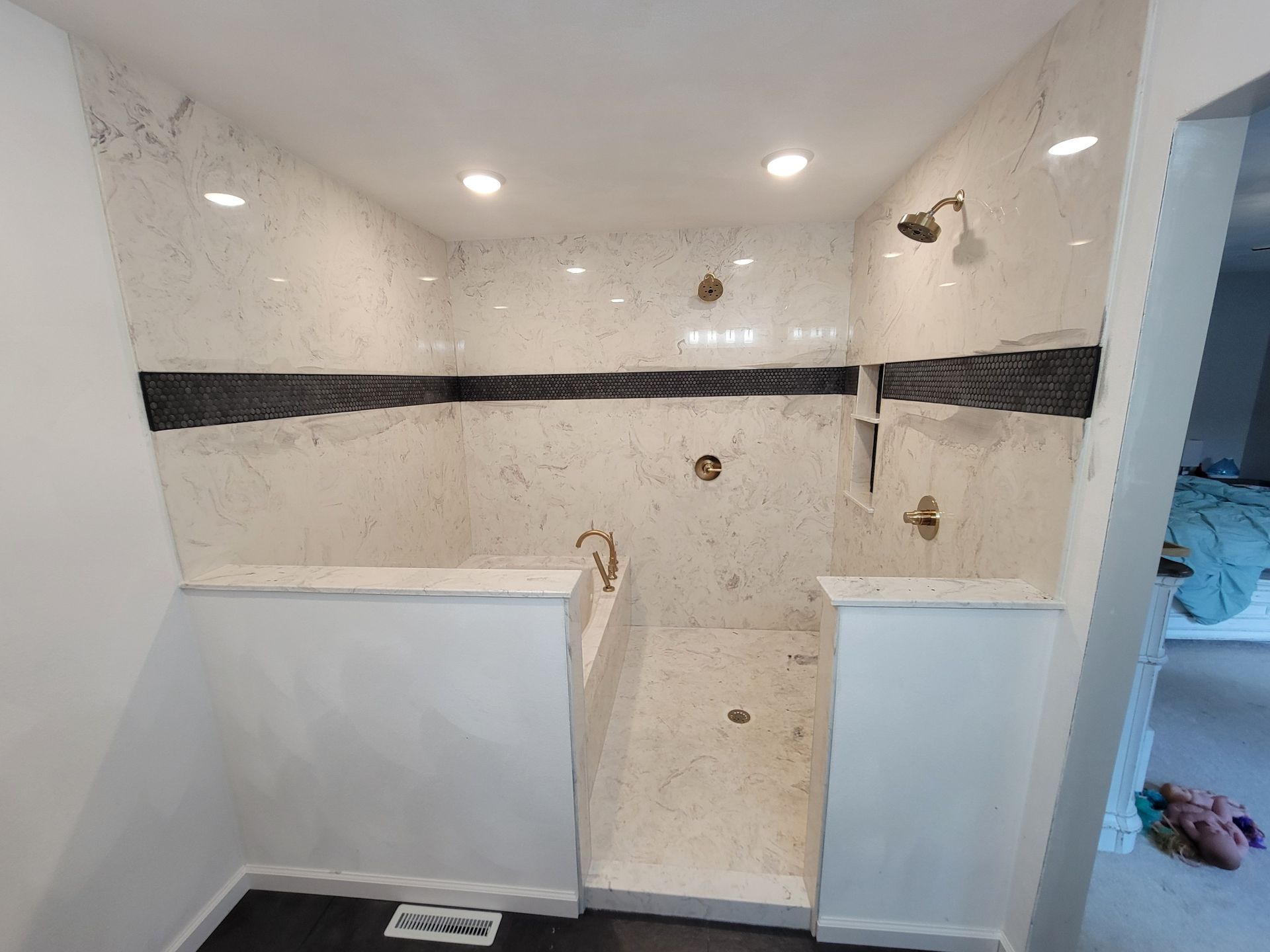 A bathroom with a walk in shower and a bathtub.