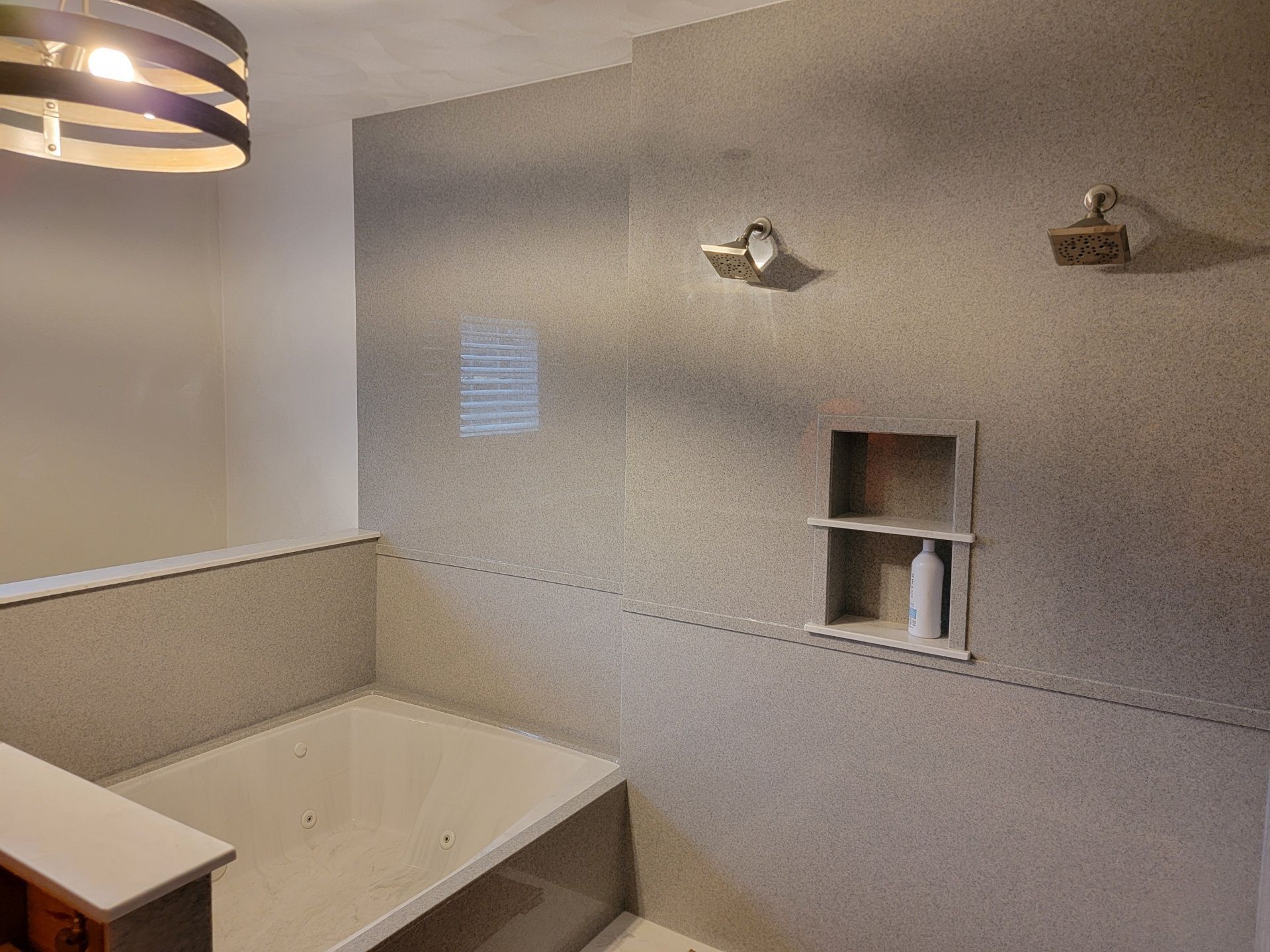 A bathroom with a bathtub and a shower.