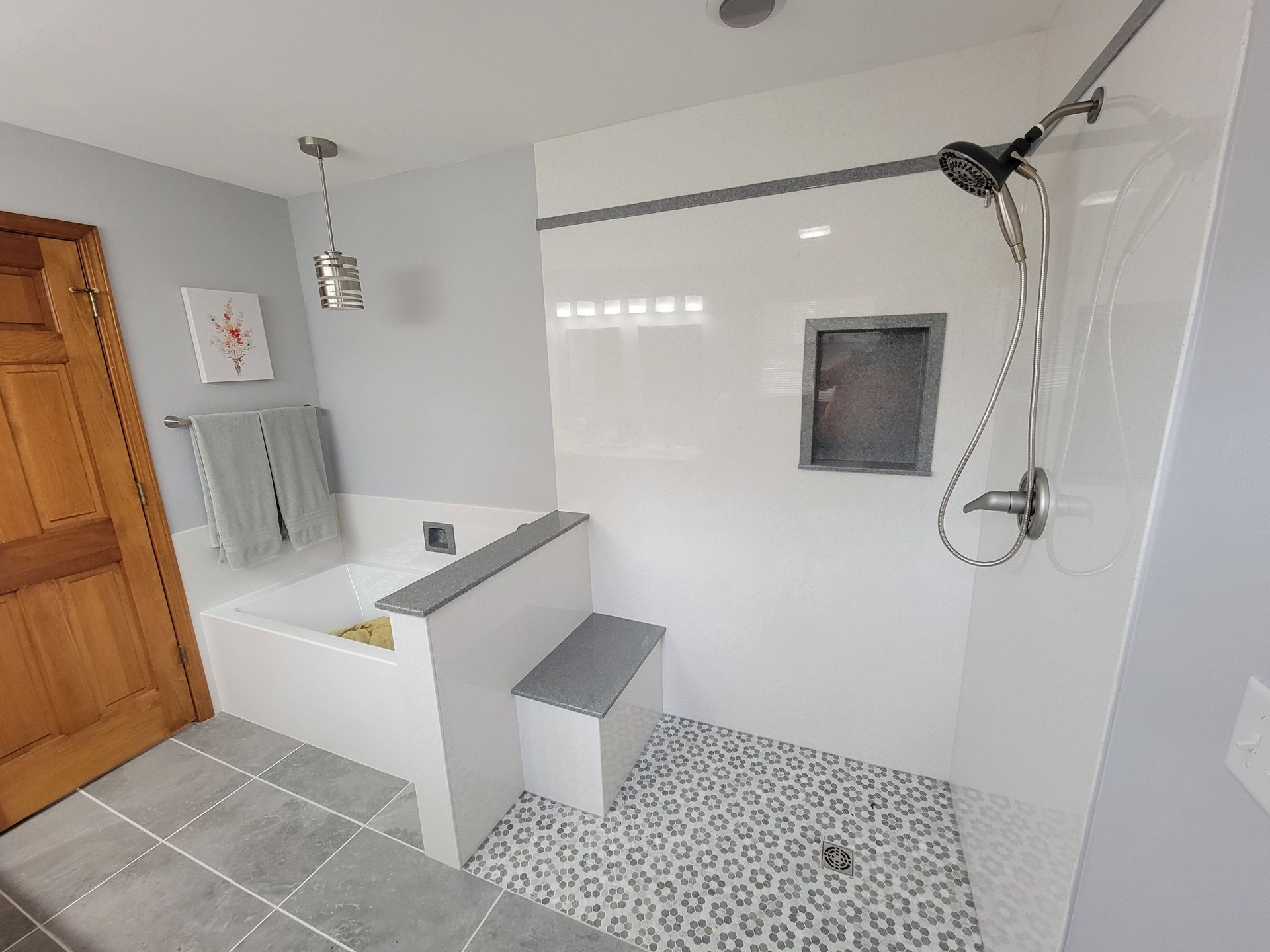 A bathroom with a bathtub and a walk in shower.