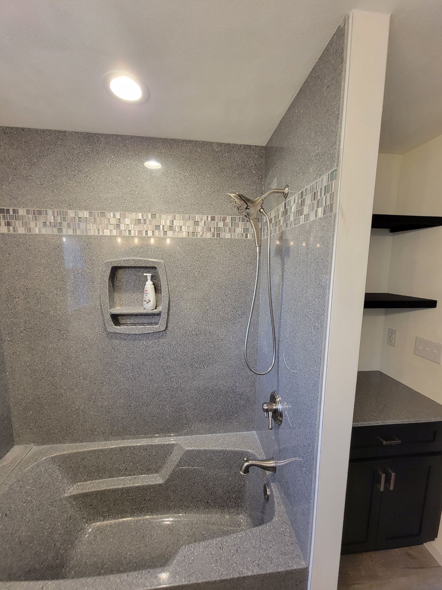 A bathroom with a bathtub and a shower.