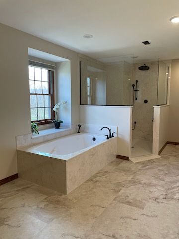 A bathroom with a walk in shower and a bathtub.