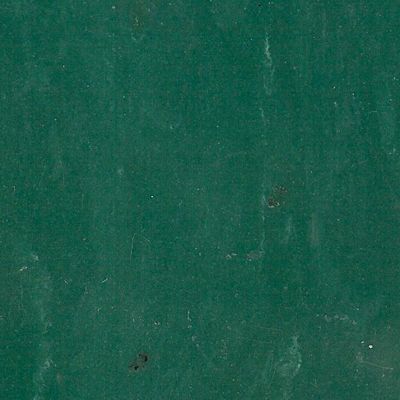 A close up of a green chalkboard with a few spots on it.