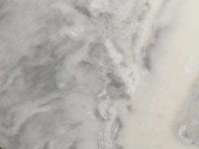 A close up of a white marble counter top.