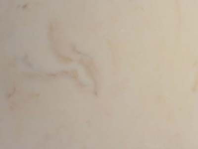 A close up of a white tile with a marble texture.