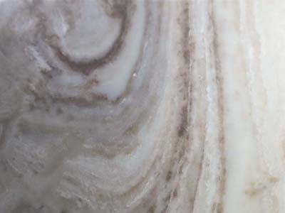 A close up of a marble surface with a swirl pattern.