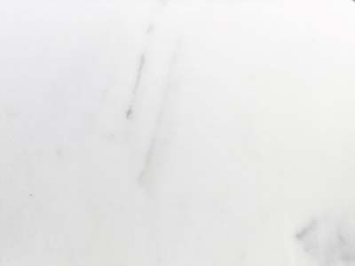 A close up of a white marble counter top.