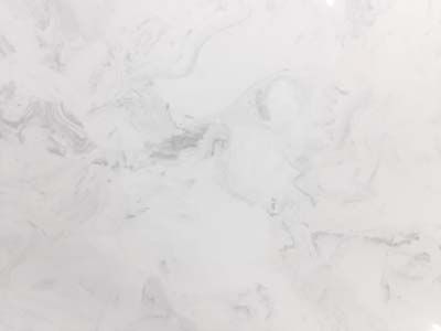 A close up of a white marble counter top.