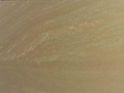 A close up of a brown tile with a marble texture.