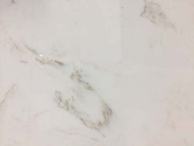 A close up of a white marble counter top.