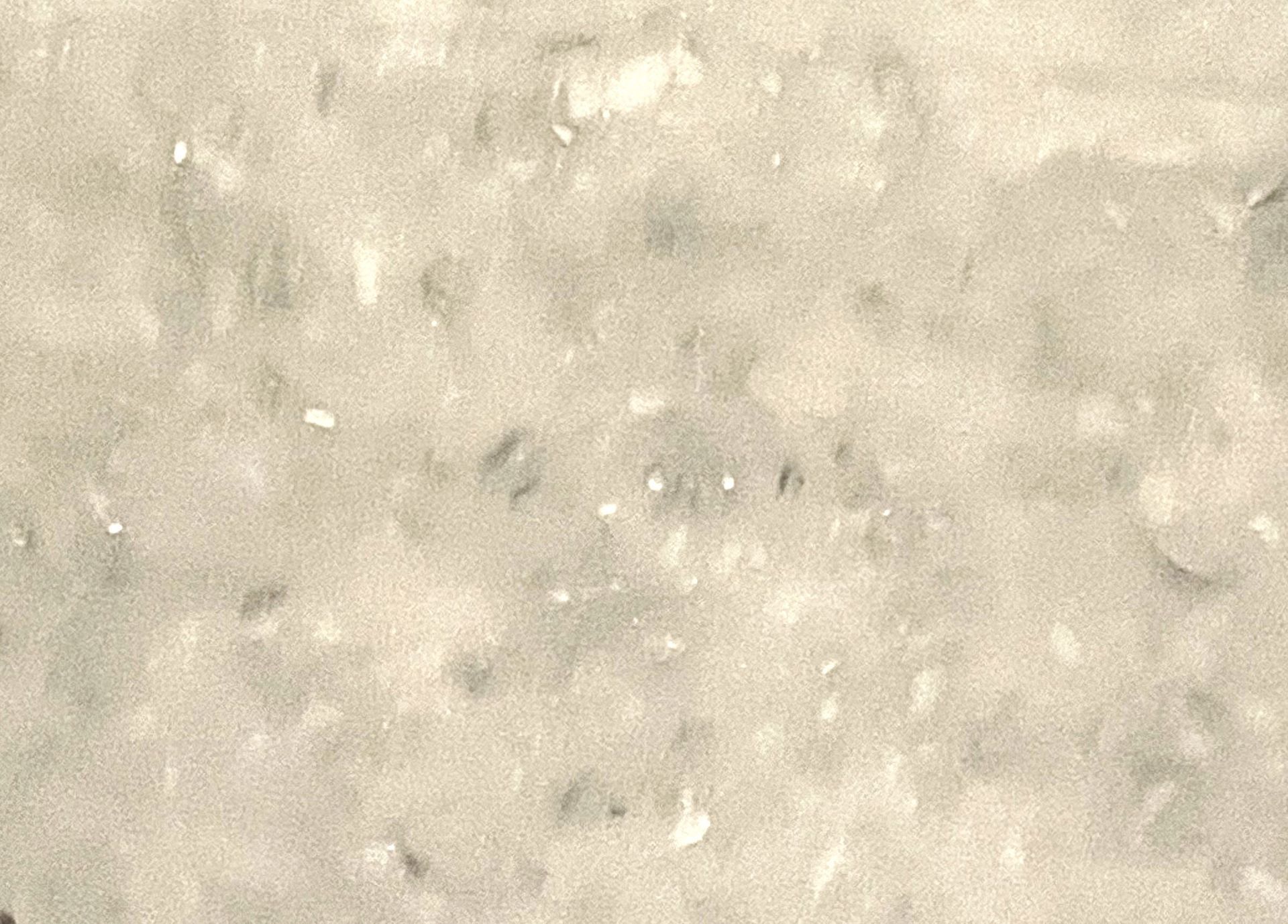 A close up of a white surface with a lot of small stones on it.