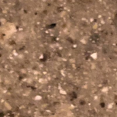 A close up of a brown granite counter top.