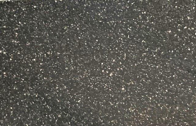 A black surface with white dots on it