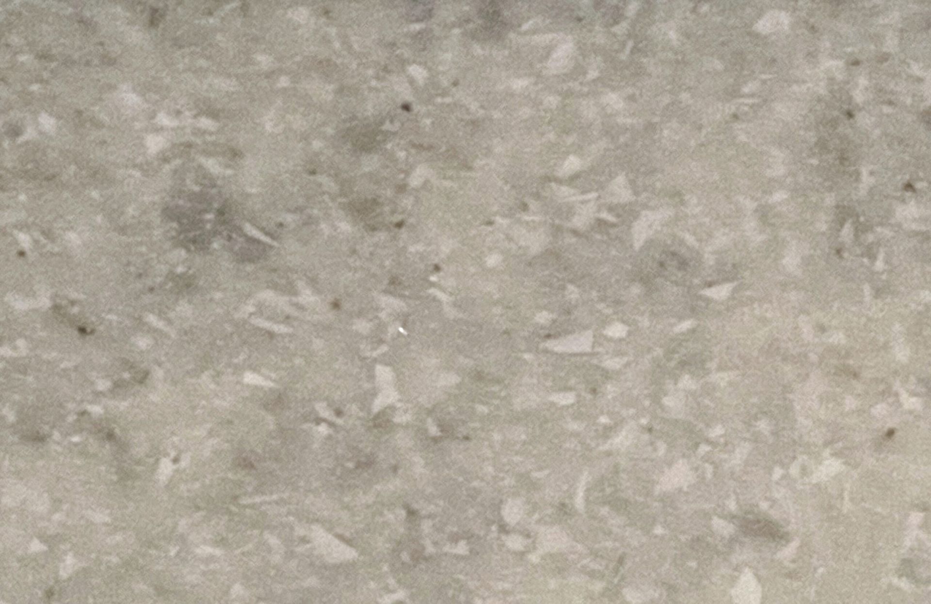 A close up of a white granite counter top.