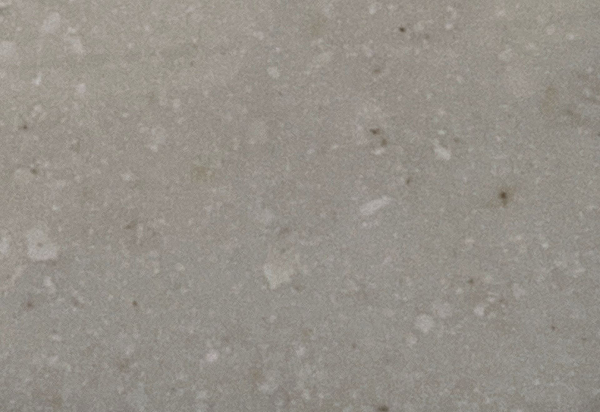A close up of a white surface with a lot of small dots on it.