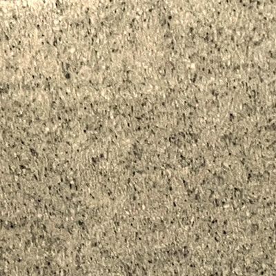 A close up of a carpet with a lot of small stones on it.