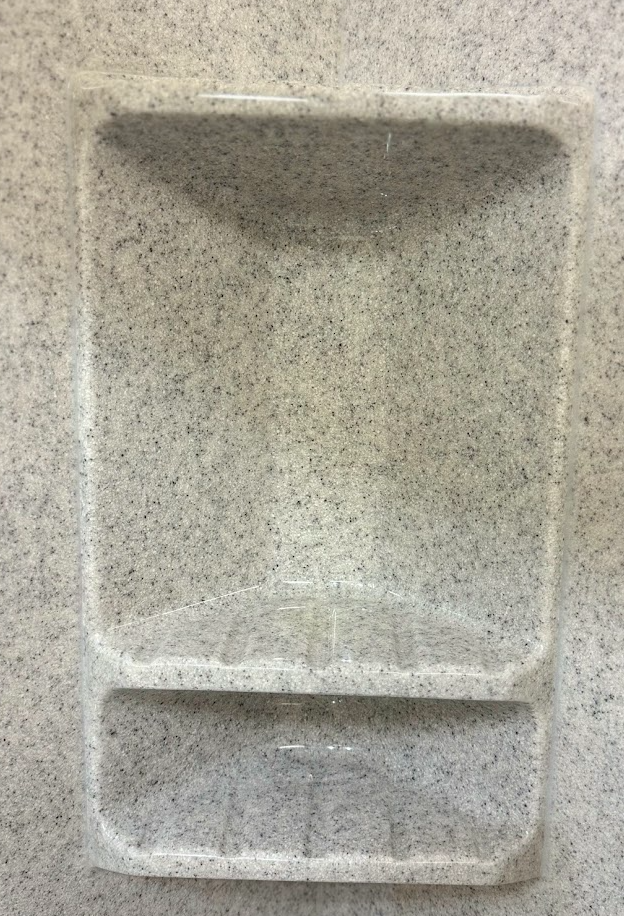 A shower with a shower head hanging from the ceiling