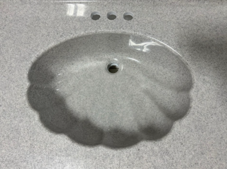 The sink is shaped like a pumpkin and has a hole in the middle.