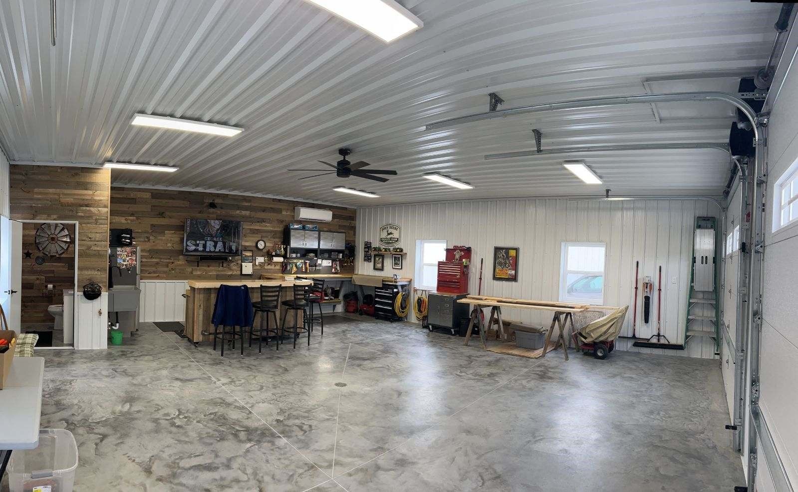 Interior of building with decorative concrete, bar, and tool bench.