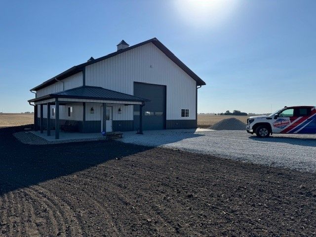 New tan building with brown roof and overhang roof on the left that looks like a patio roof.