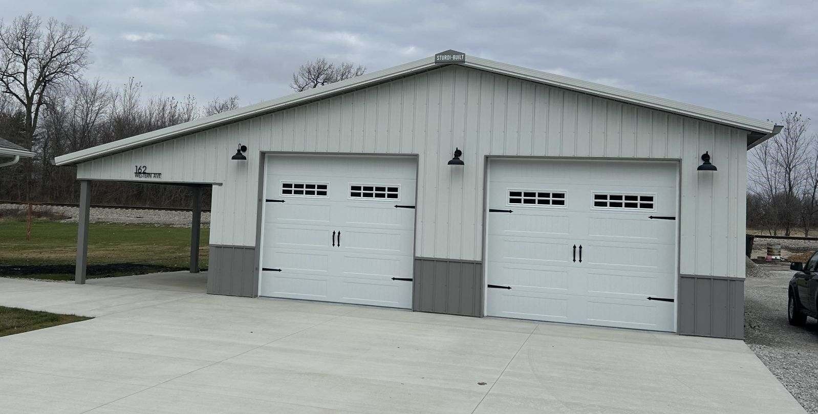 Light tan building with two garage doors.