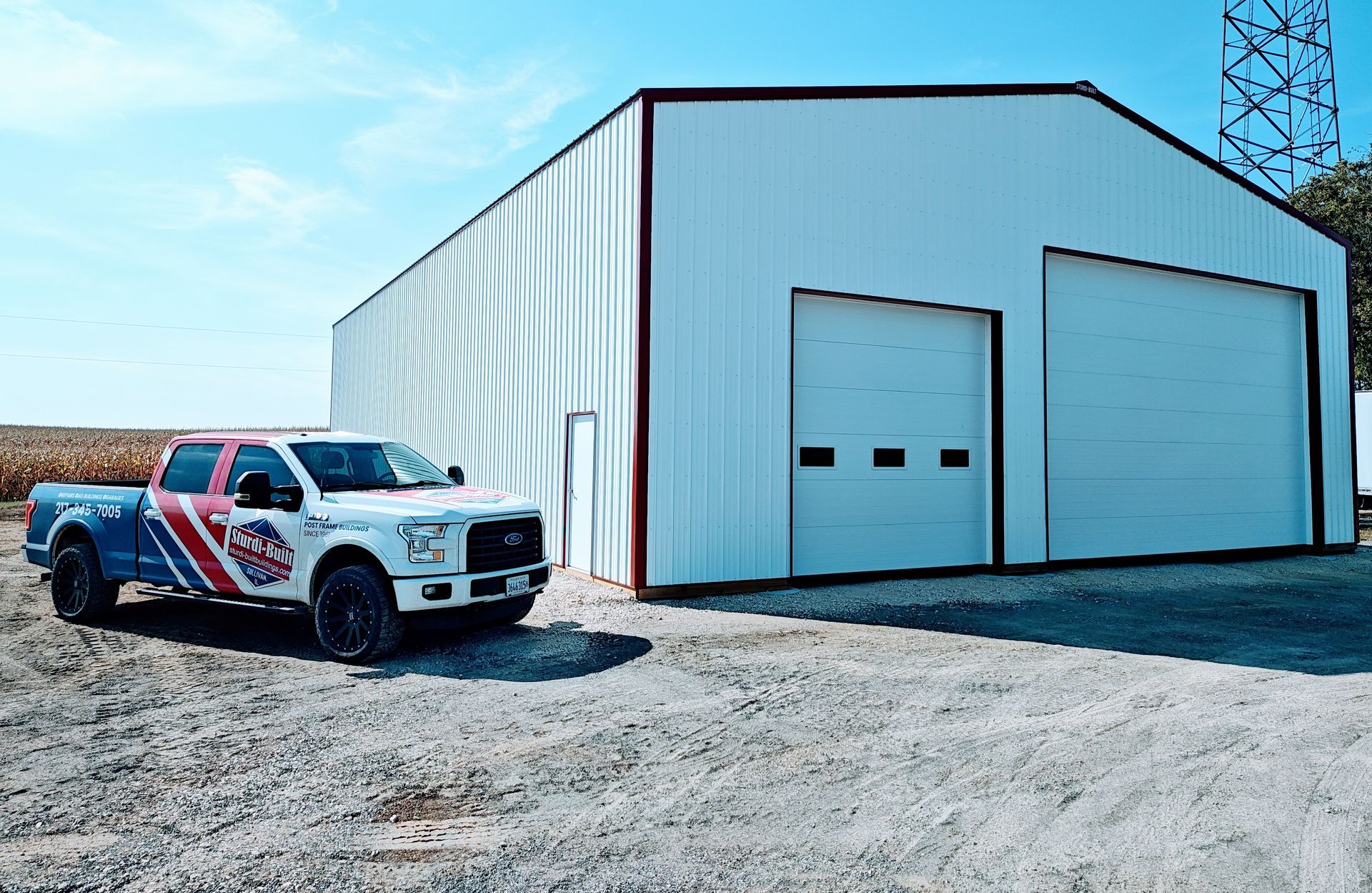 White building with Sturdi-built truck parked on the left side.