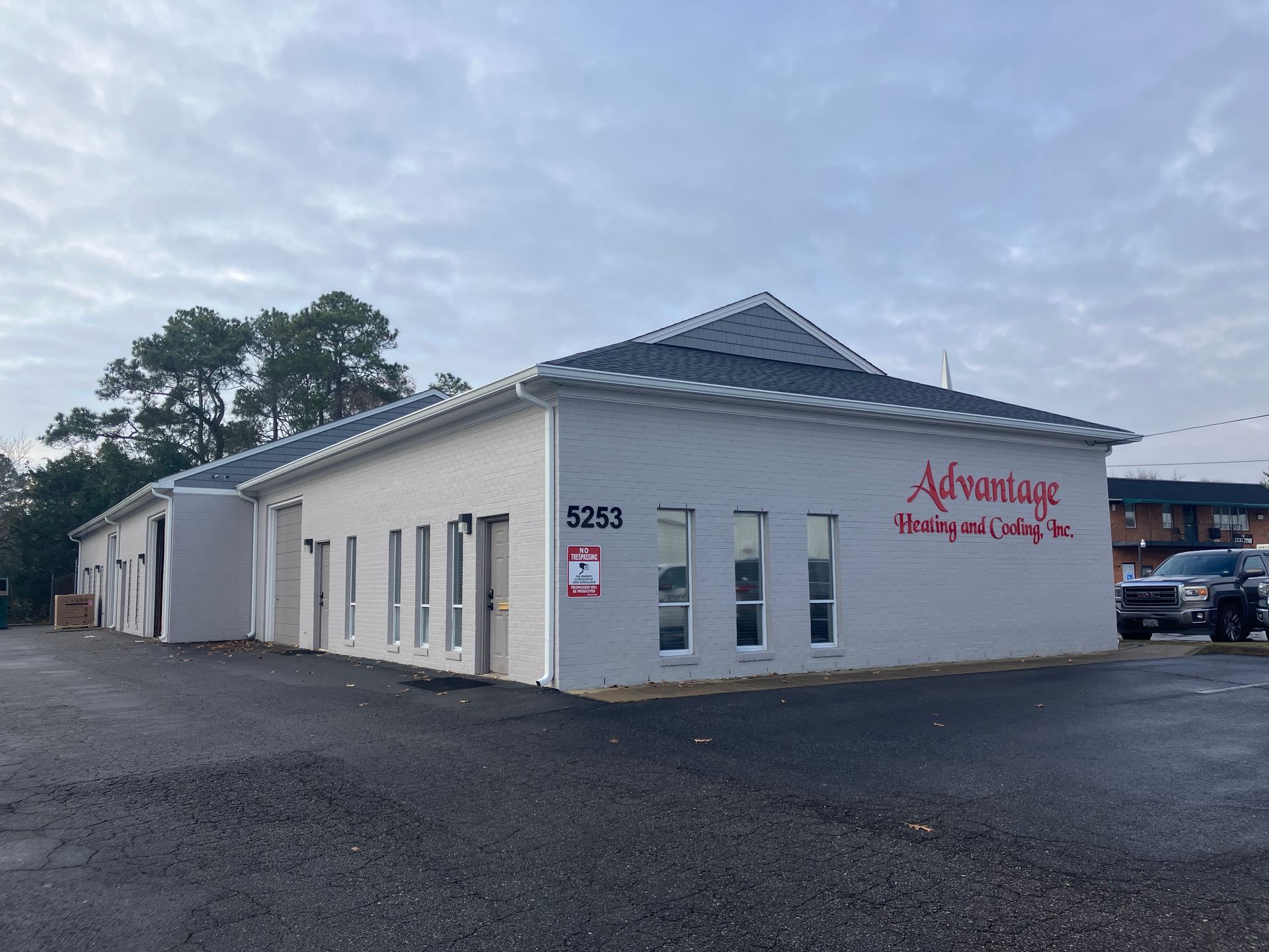 A white building with red writing on the side of it.