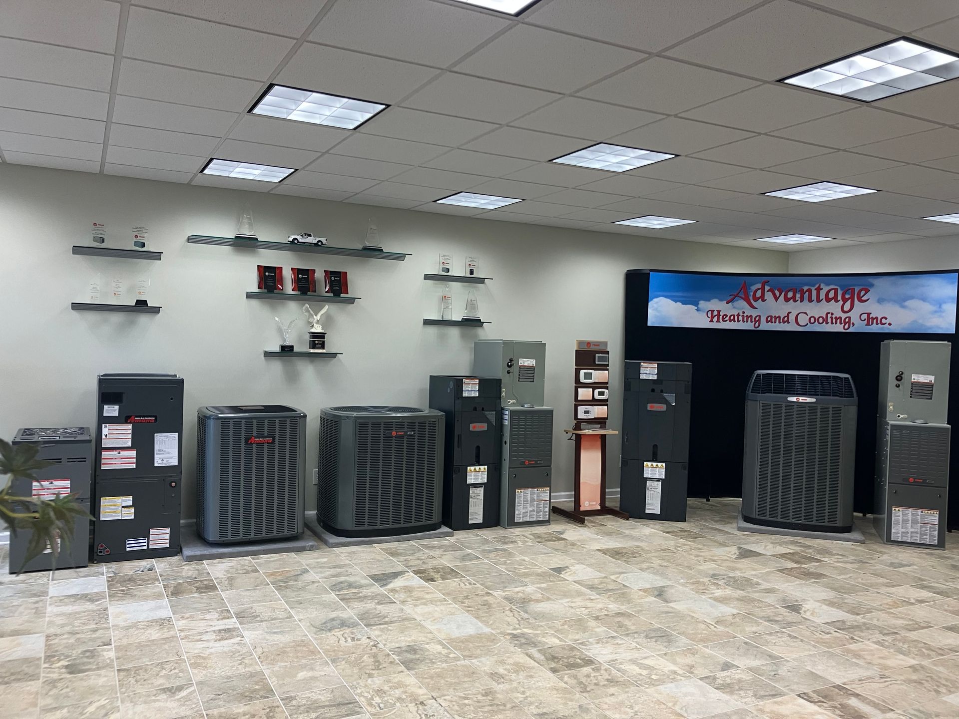 A room filled with air conditioners and a sign that says advantage