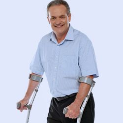 Man standing with crutches
