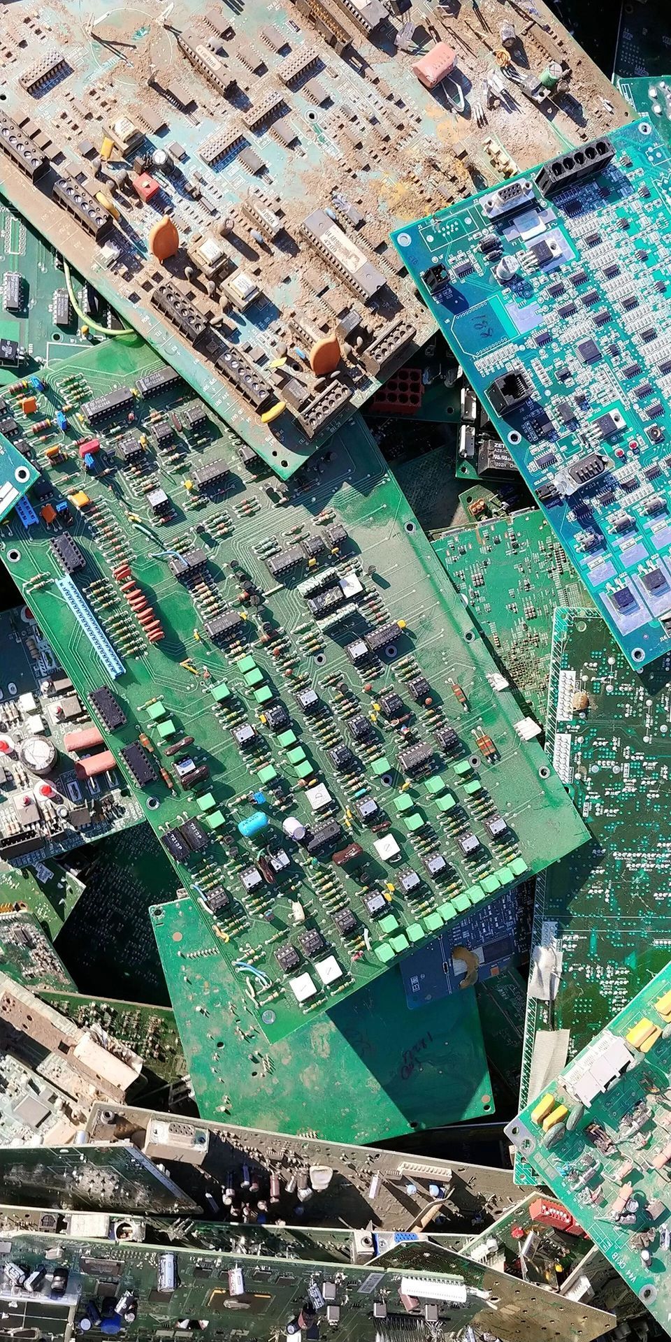 Pile of discarded green circuit boards