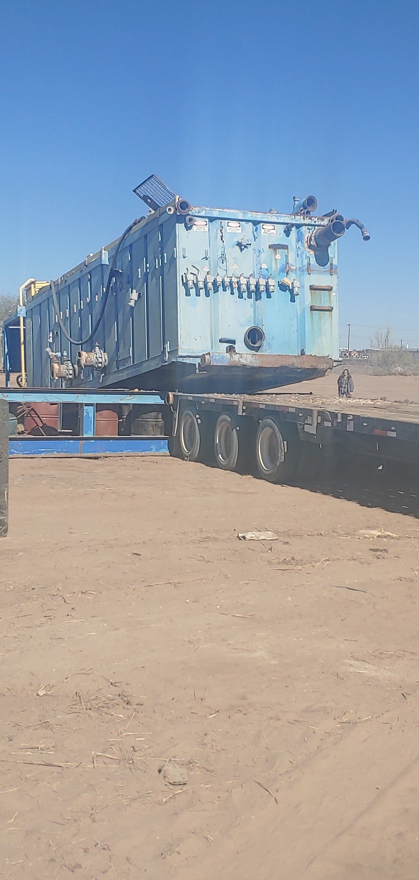 Large blue industrial structure on a flatbed trailer