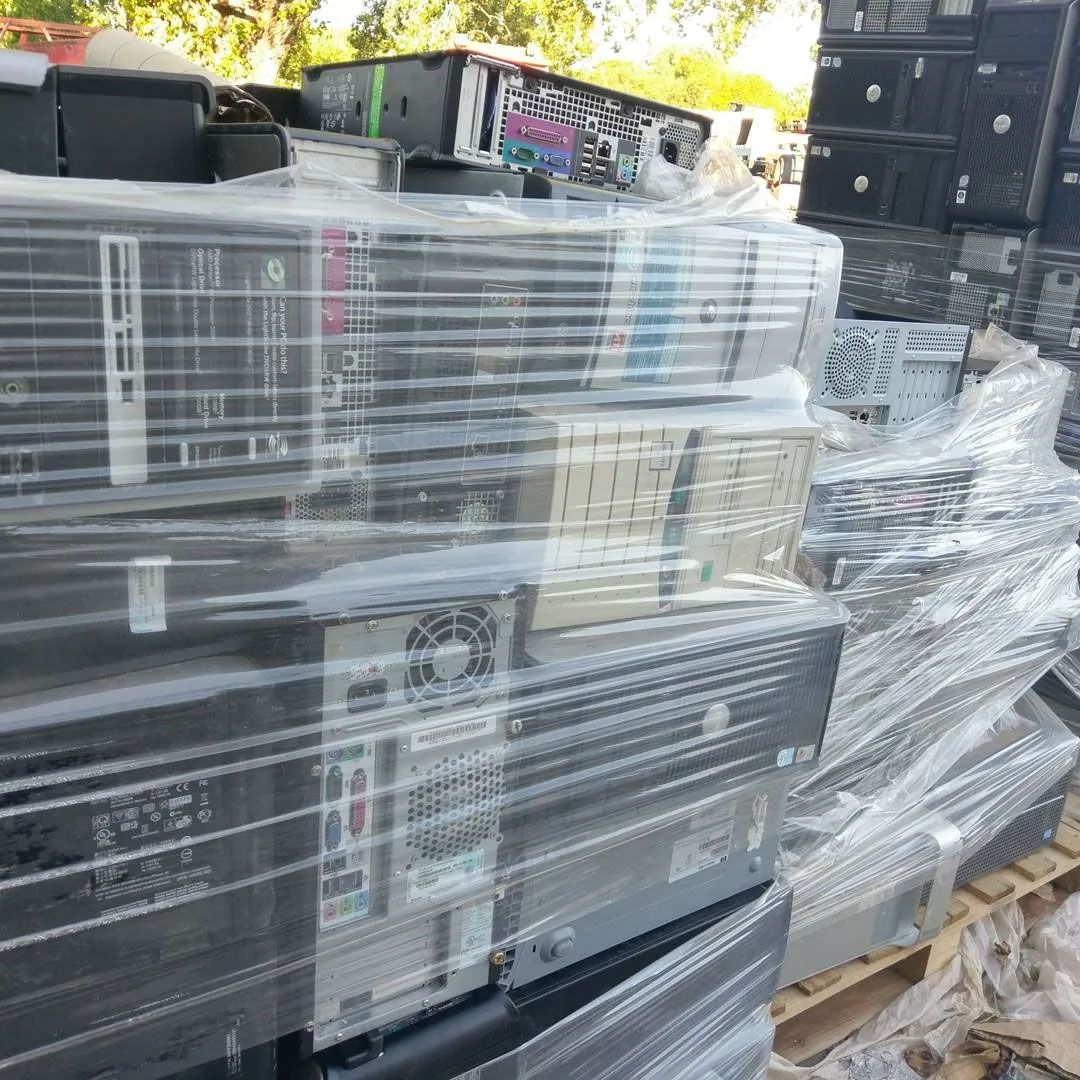 Pile of used computers wrapped in plastic on a wooden pallet